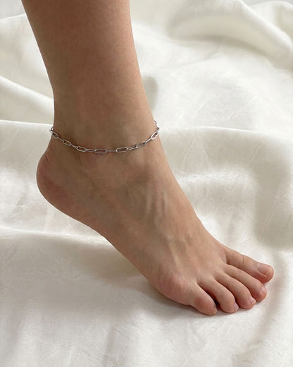 Silver paperclip chain anklet on a foot 