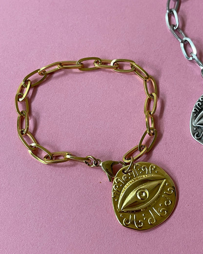 Evil eye charm bracelet with paperclip chain and a round eye charm in gold 
