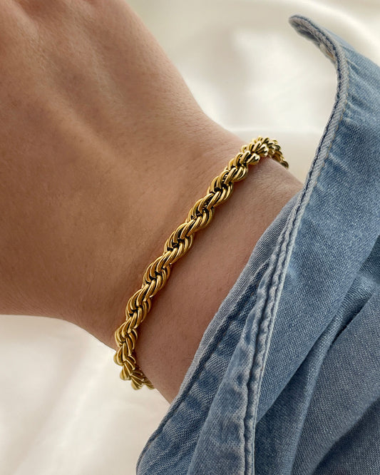 Hand wearing a waterproof gold rope chain bracelet