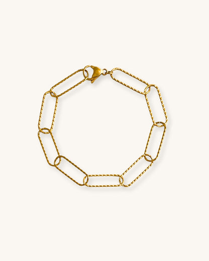 Gold link chain bracelet on a white background