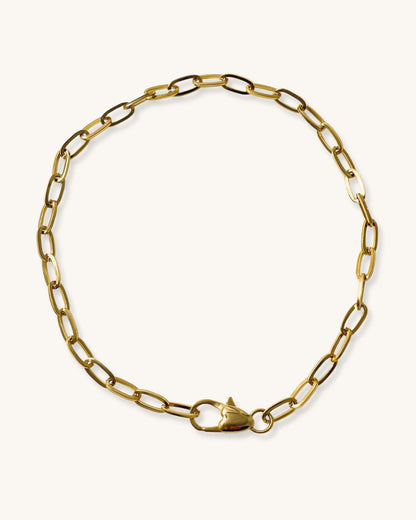 A gold chain necklace with a heart shaped closure. The chain is made of oval-shaped links.