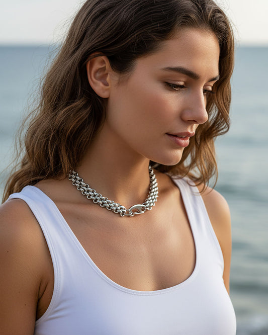 Model wearing a silver chainmail necklace with a large lobster clasp