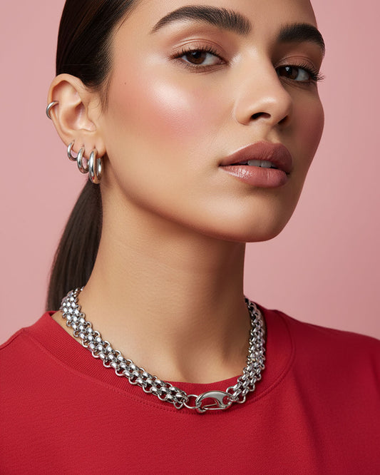 Model wearing a silver chainmail necklace with a large lobster clasp