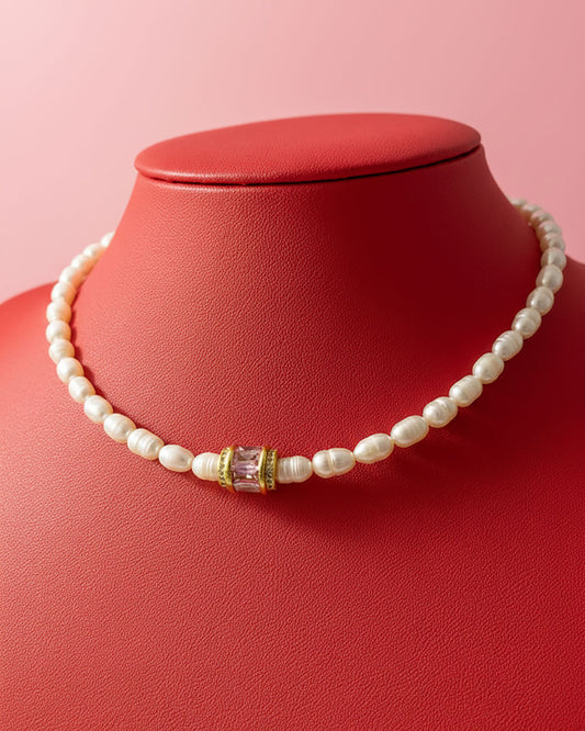 pearl choker necklace with a pink crystal bead in the middle