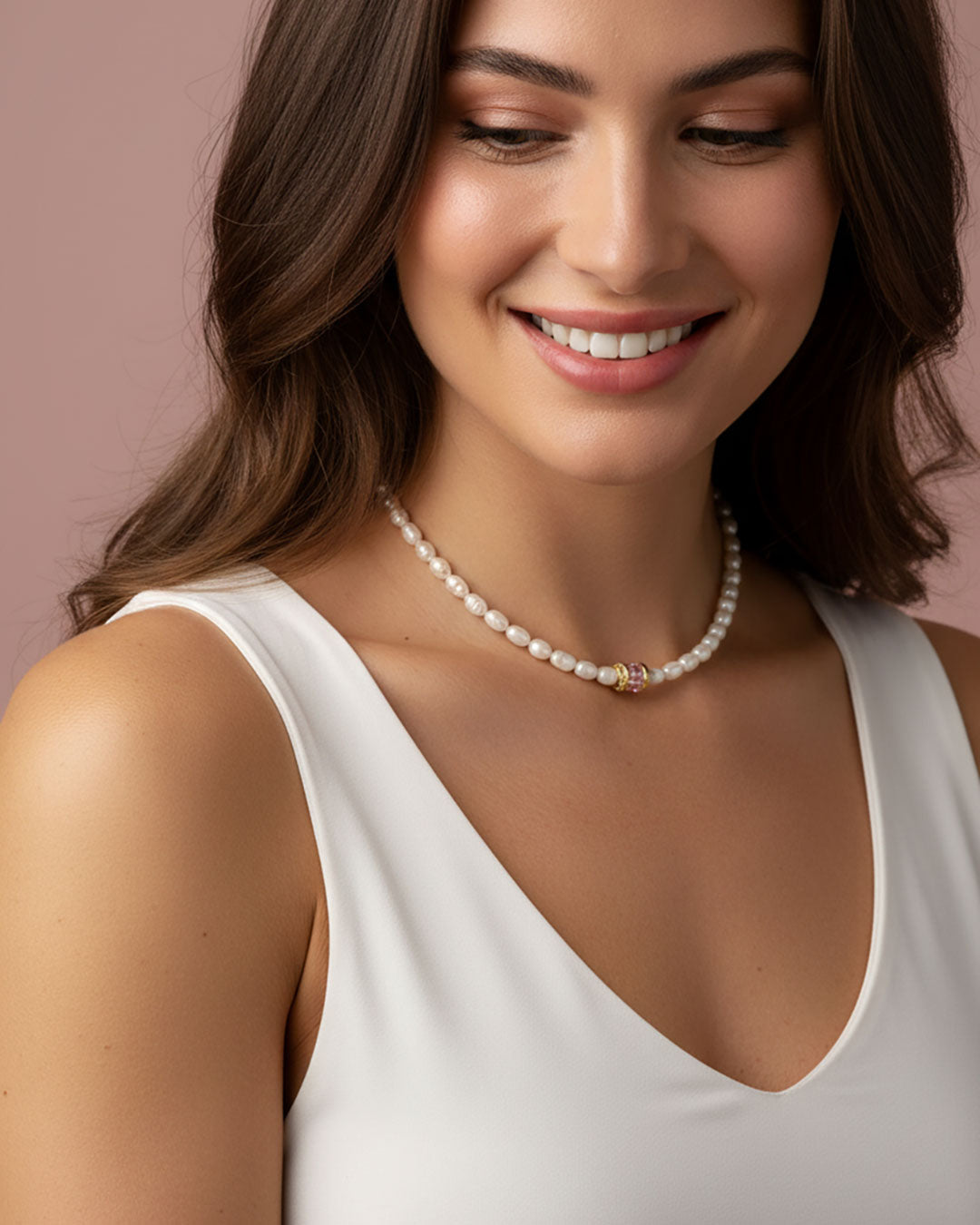 Model wearing a pearl choker necklace with a pink crystal bead in the middle