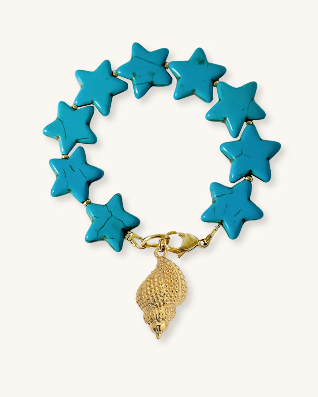 Turquoise star-shaped bracelet with a gold shell charm on a natural background