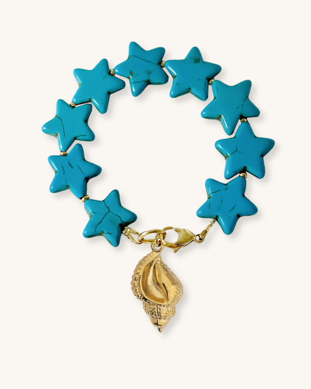 Turquoise star-shaped bracelet with a gold shell charm on a natural background