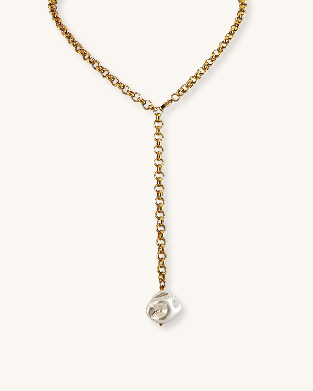 Gold chain necklace with a mop shell pearl pendant on a white background