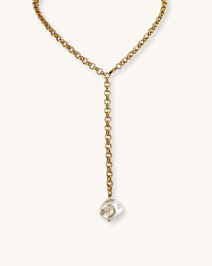 Gold chain necklace with a mop shell pearl pendant on a white background