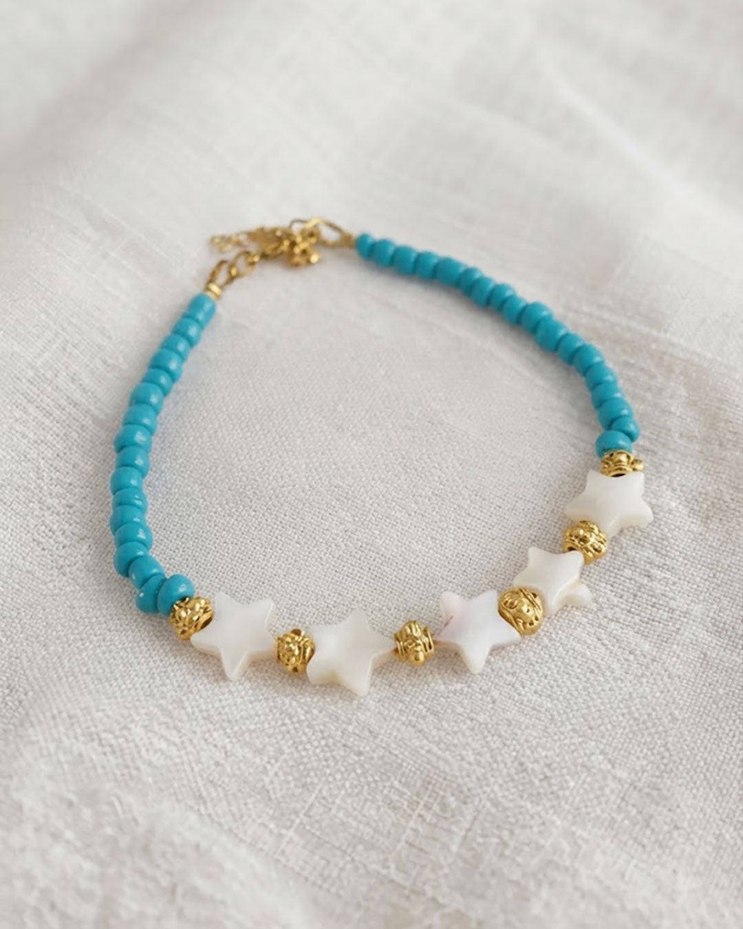 A Blue Boho Stars Beaded Anklet adorned with blue beads abd shell stars