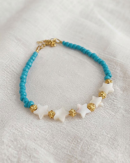A Blue Boho Stars Beaded Anklet adorned with blue beads abd shell stars
