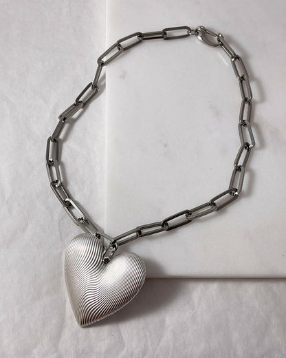 Chunky silver necklace with large heart pendant and paperclip chain