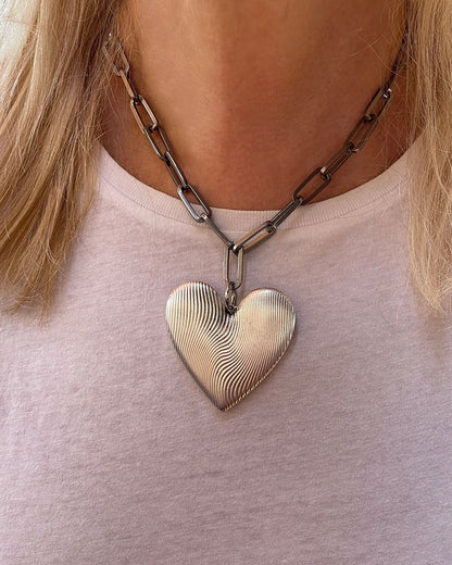 Chunky silver necklace with large heart pendant and paperclip chain