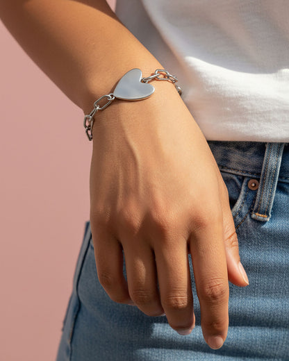 Silver heart-shaped bracelet on a wrist