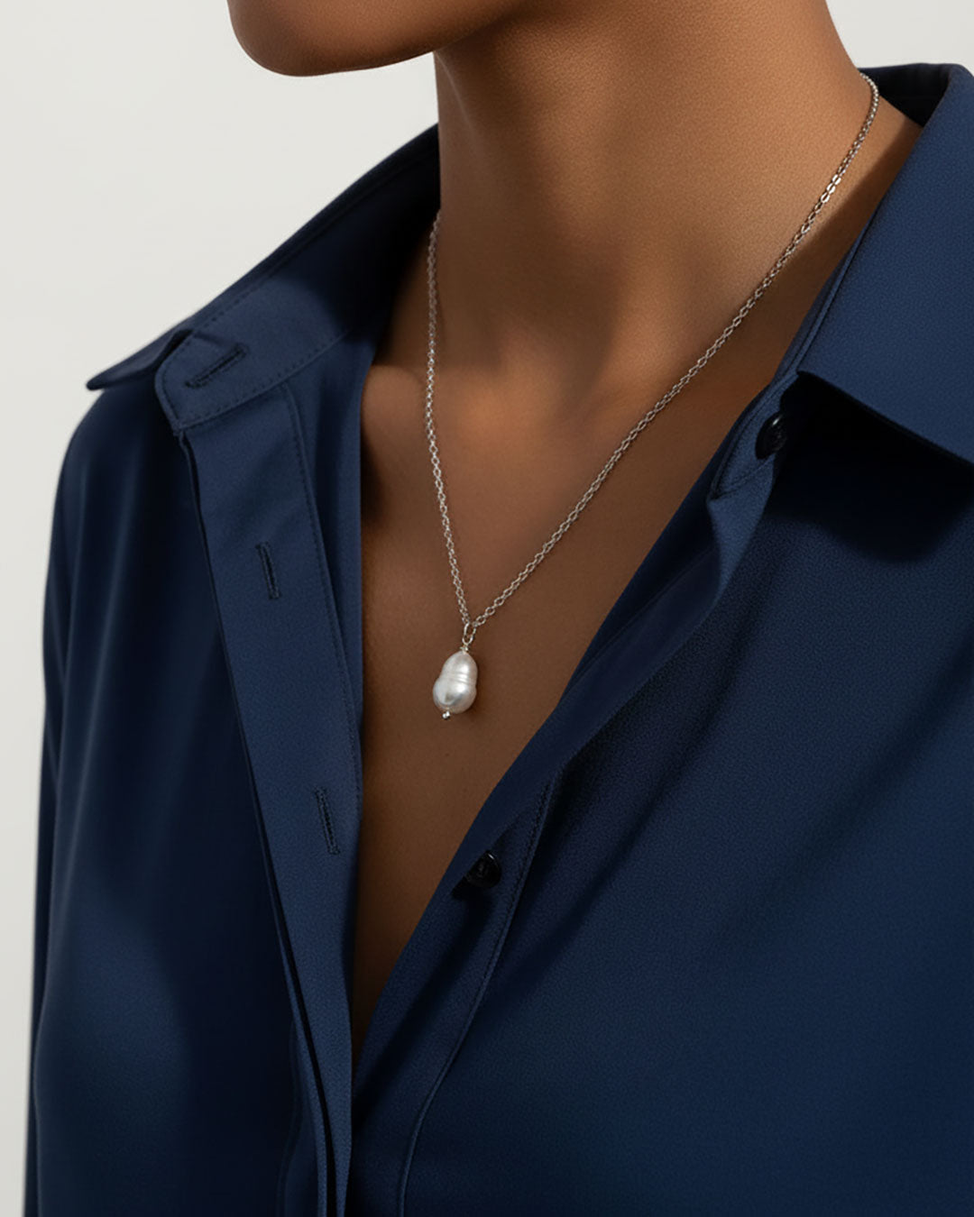Model wearing a single pearl necklace in silver