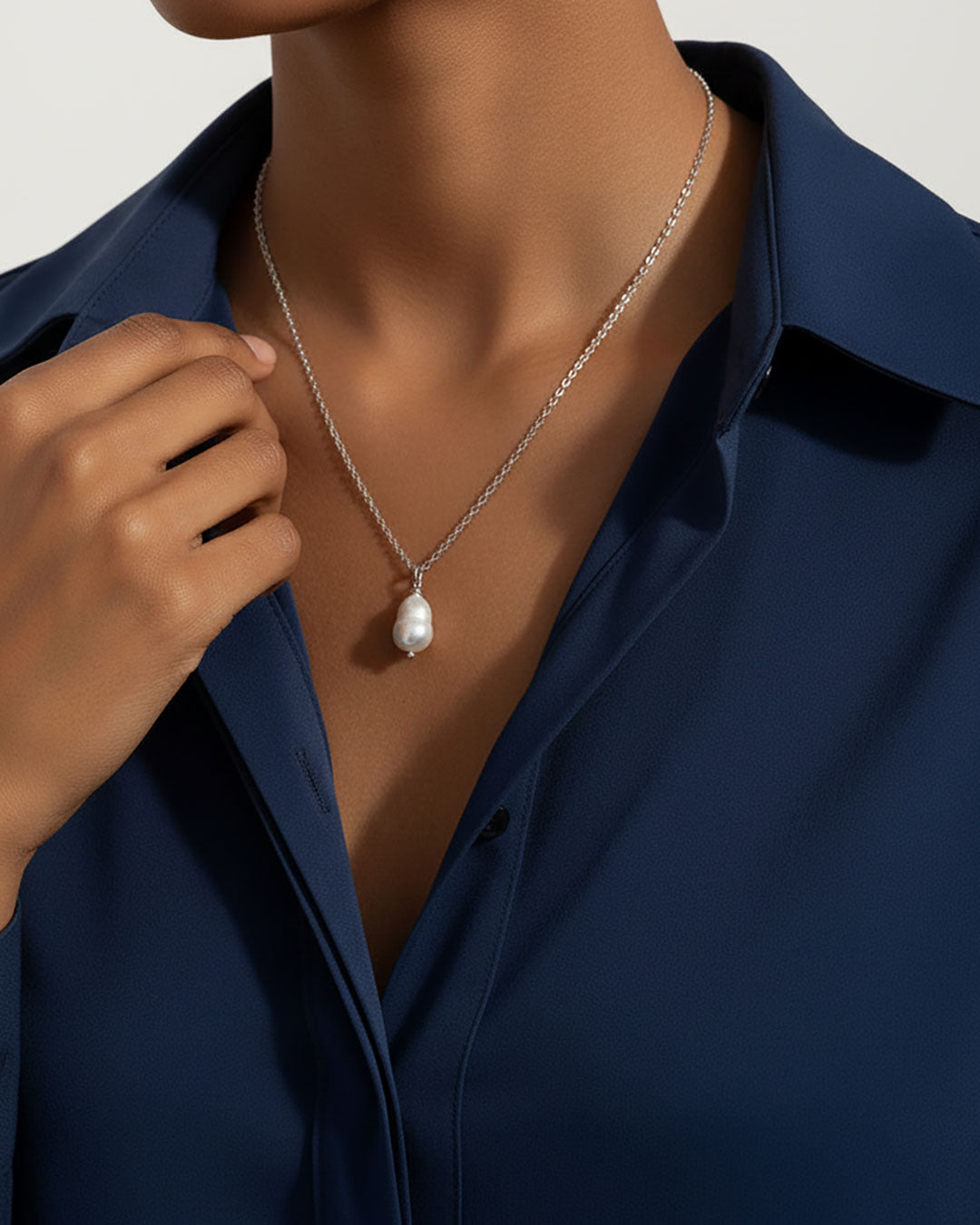 Model wearing a single pearl necklace in silver