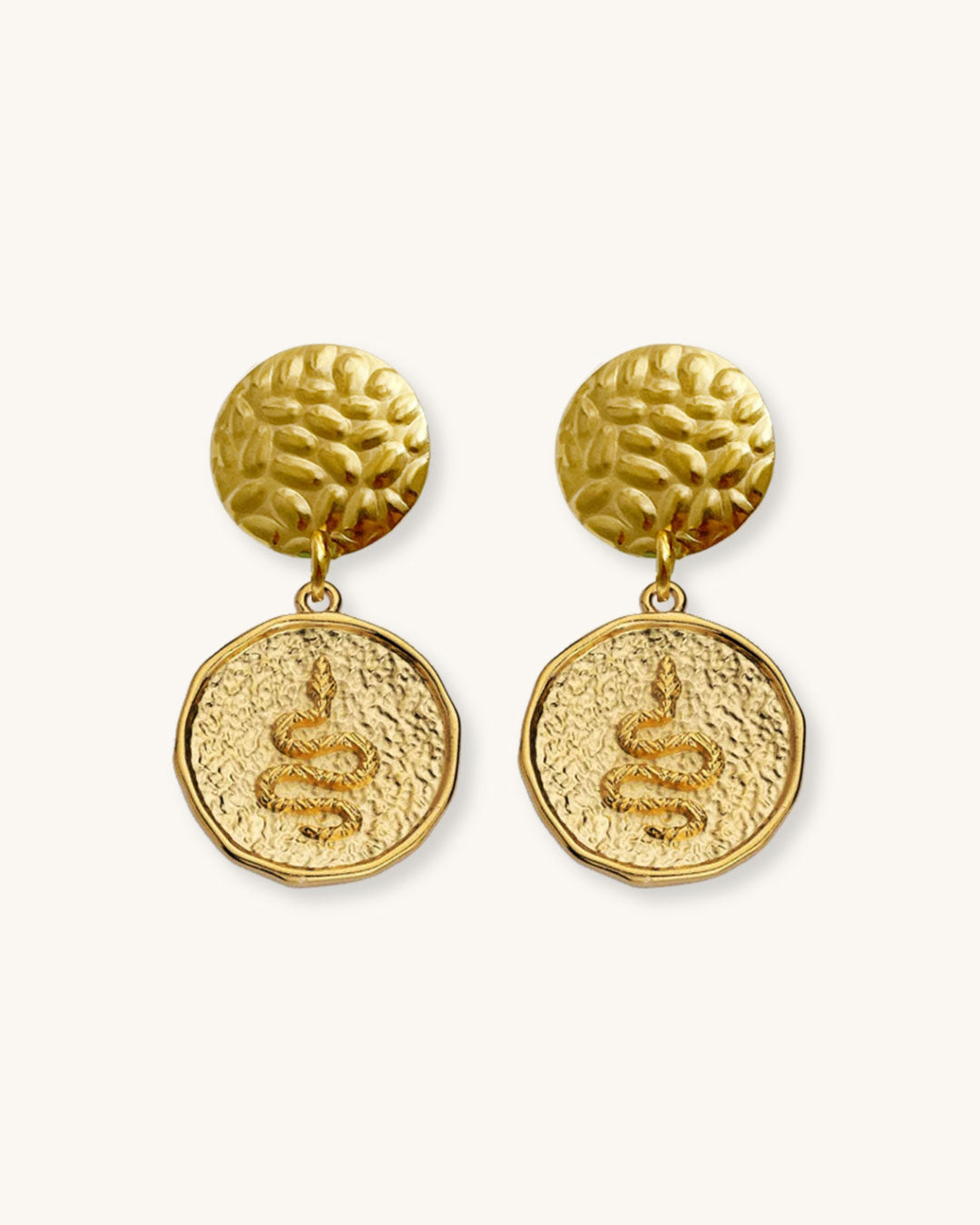 The Snake Earrings, a pair of gold earrings featuring a round snake charm.