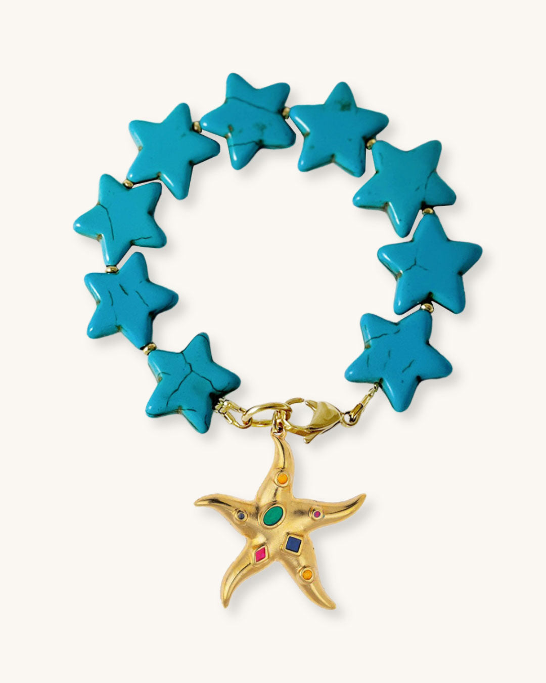 A turquoise star-shaped howlite beaded bracelet with a gold colorful starfish charm on a white background