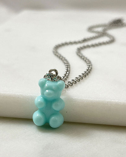 An acrylic turquoise teddy bear pendant on a dainty stainless steel silver chain