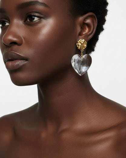 Model wearing a gold Statement Earrings with a large clear acrylic heart 