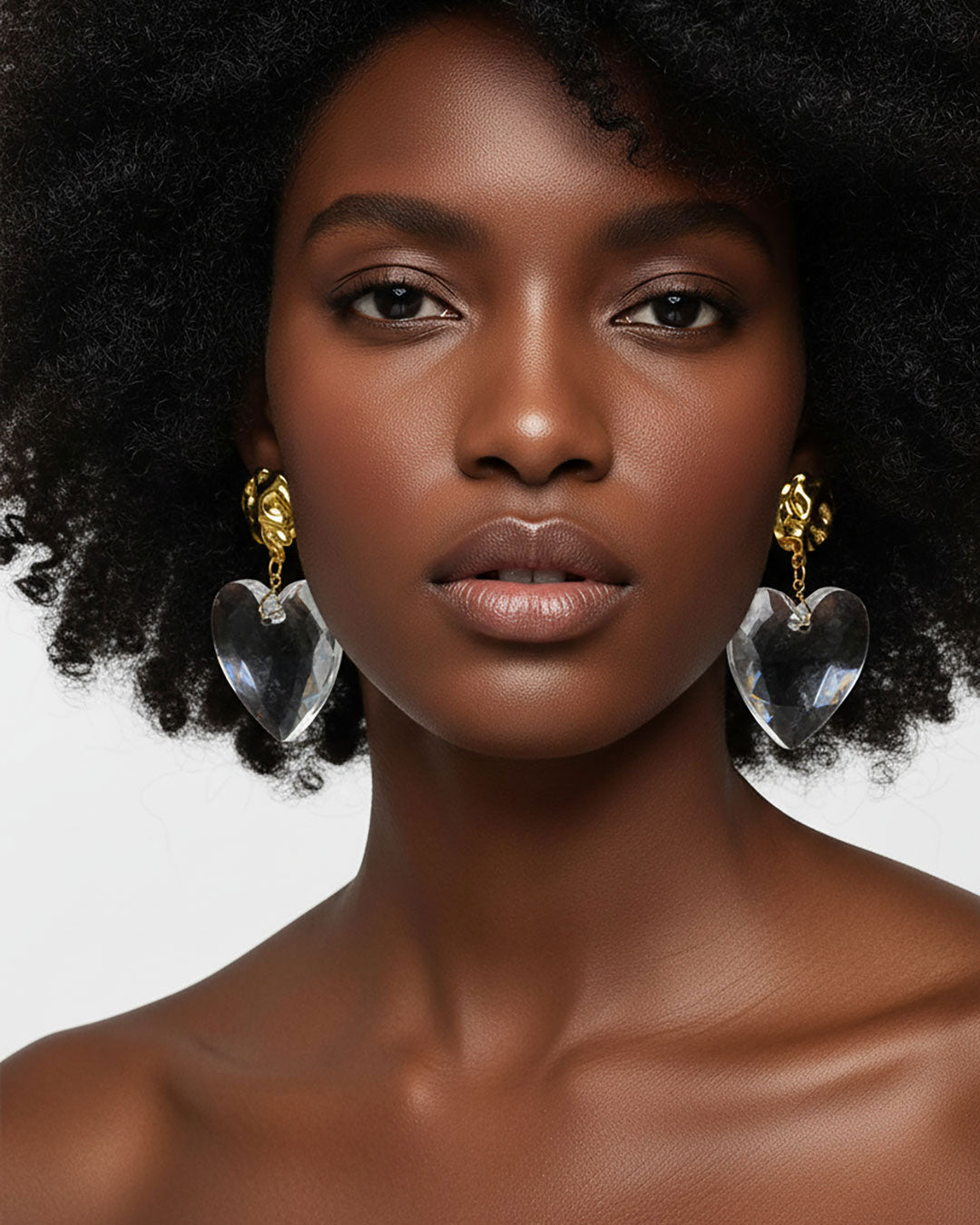 Model wearing a gold Statement Earrings with a large clear acrylic heart 