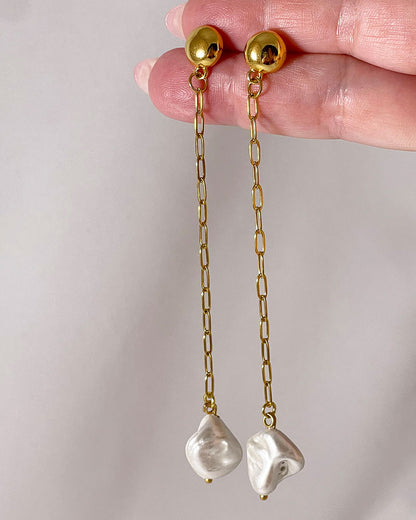 The Long Pearl Shell Earrings, a pair of stud earrings featuring a paperclip chain with a shell pearl pendant.