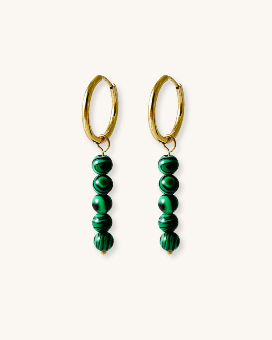 Gold hoop earrings with malachite green beads on a white background