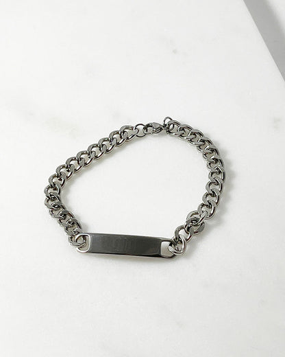 A chunky curb chain bracelet in silver connected by a solid bar at the center.