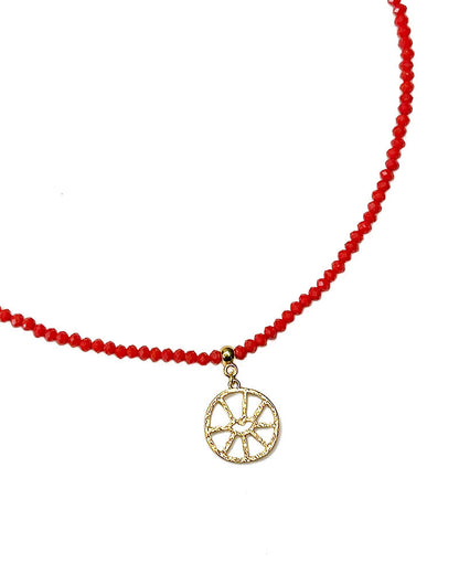 A red beaded necklace with an evil eye round oendant.