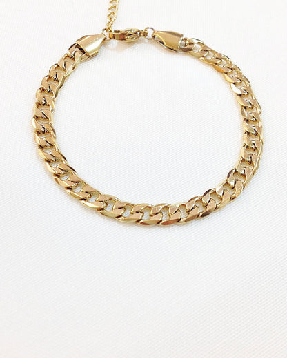 Waterproof curb chain bracelet in gold on a neutral background
