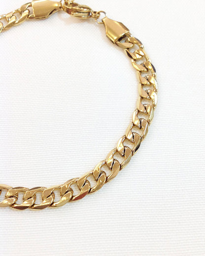 Close-up look of a gold curb chain bracelet