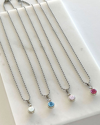 A silver chain necklace with a Swarovski crystal