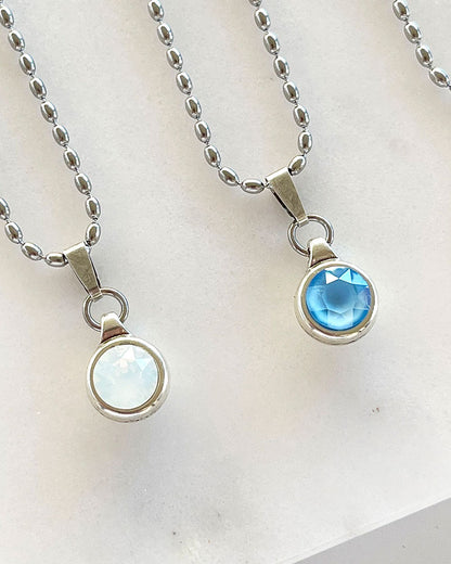 A silver chain necklace with a Swarovski crystal