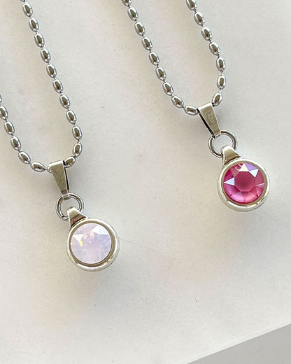 A silver chain necklace with a Swarovski crystal