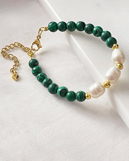 A handmade green malachite beaded bracelet with freshwater pearls. The bracelet has a gold stainless steel lobster clasp