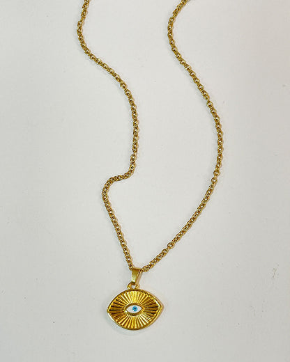 A dainty chain necklace with a small eye pendant. The pendant is gold with a white blue enamel evil eye design.