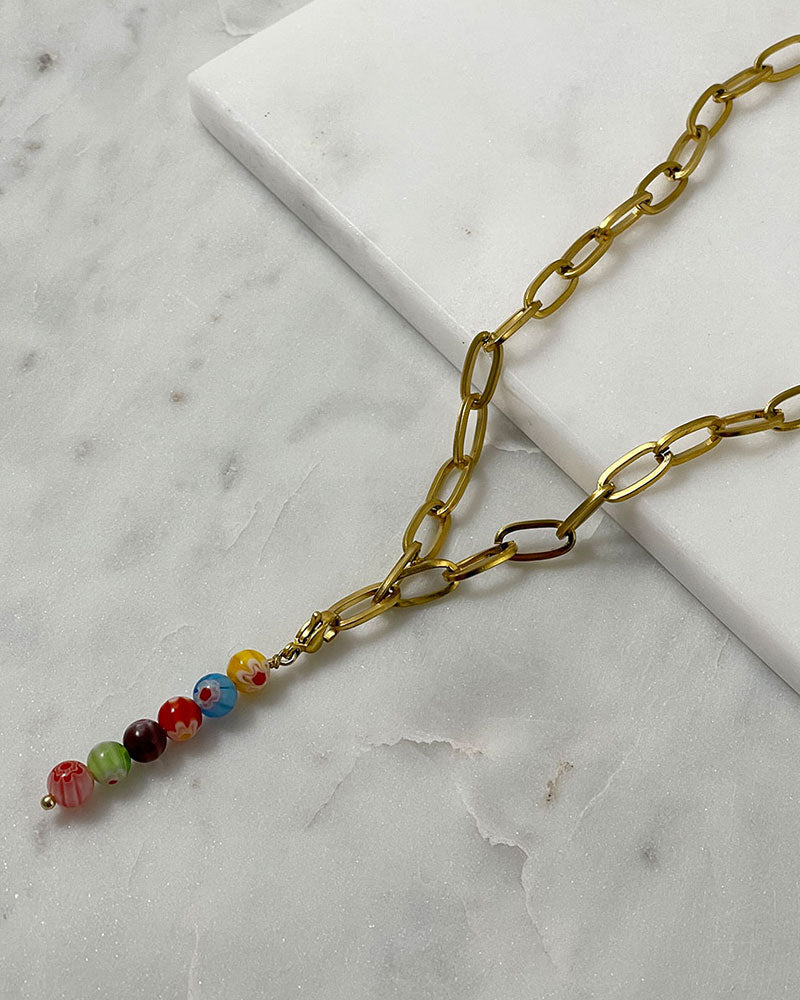 A chunky paperclip chain necklace in gold with a removable murano millefiori beads pendant