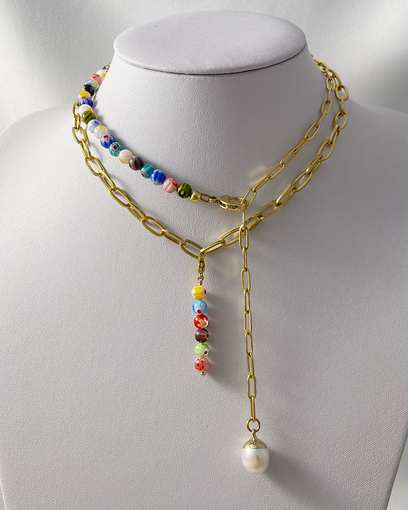 A chunky paperclip chain necklace in gold with a removable murano millefiori beads pendant