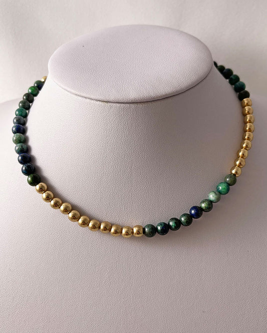 A handmade minimalist necklace with azurite and gold hematite beads