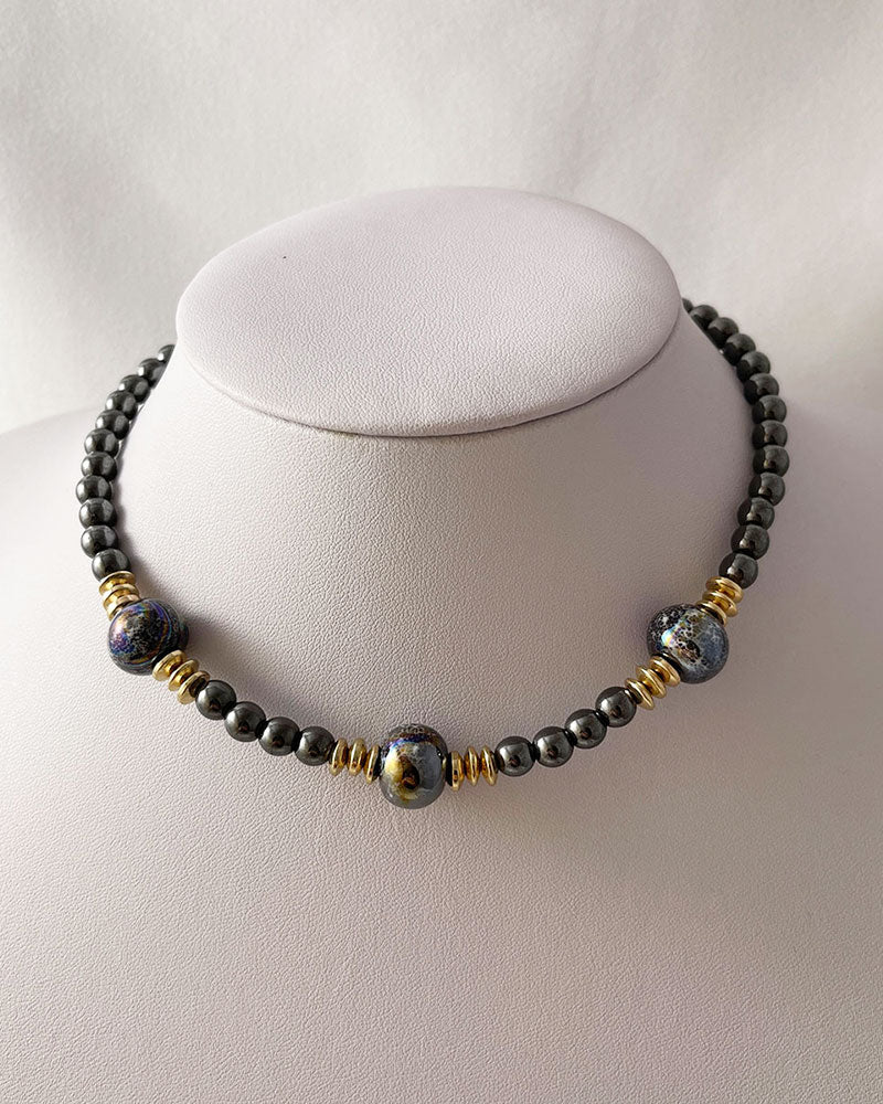 A handmade minimalist necklace with black hematite and ceramic beads