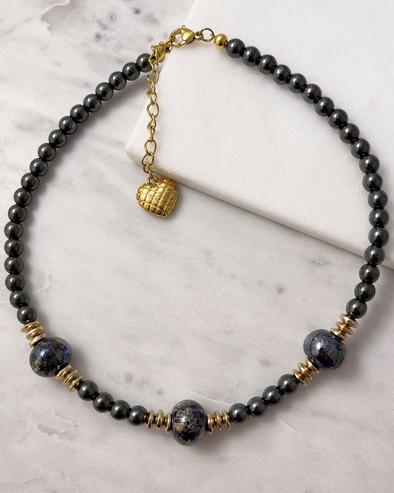 A handmade minimalist necklace with black hematite and ceramic beads