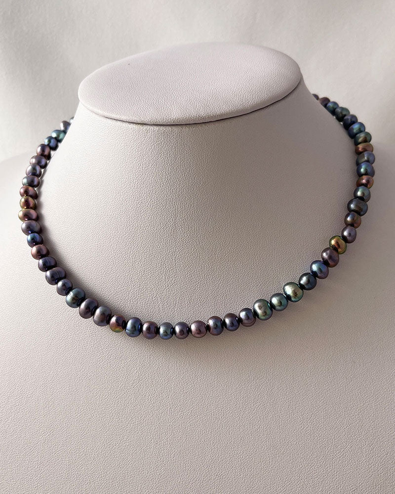 black pearl necklace in peacock overtone