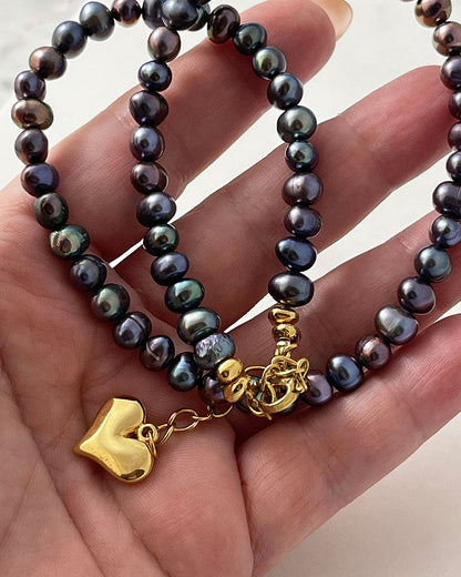black pearl necklace in peacock overtone