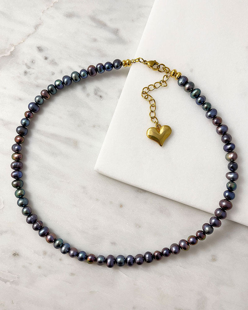 black pearl necklace in peacock overtone