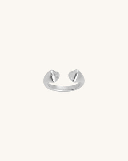 A silver double heart ring with a slightly adjustable band, displayed against a white background.