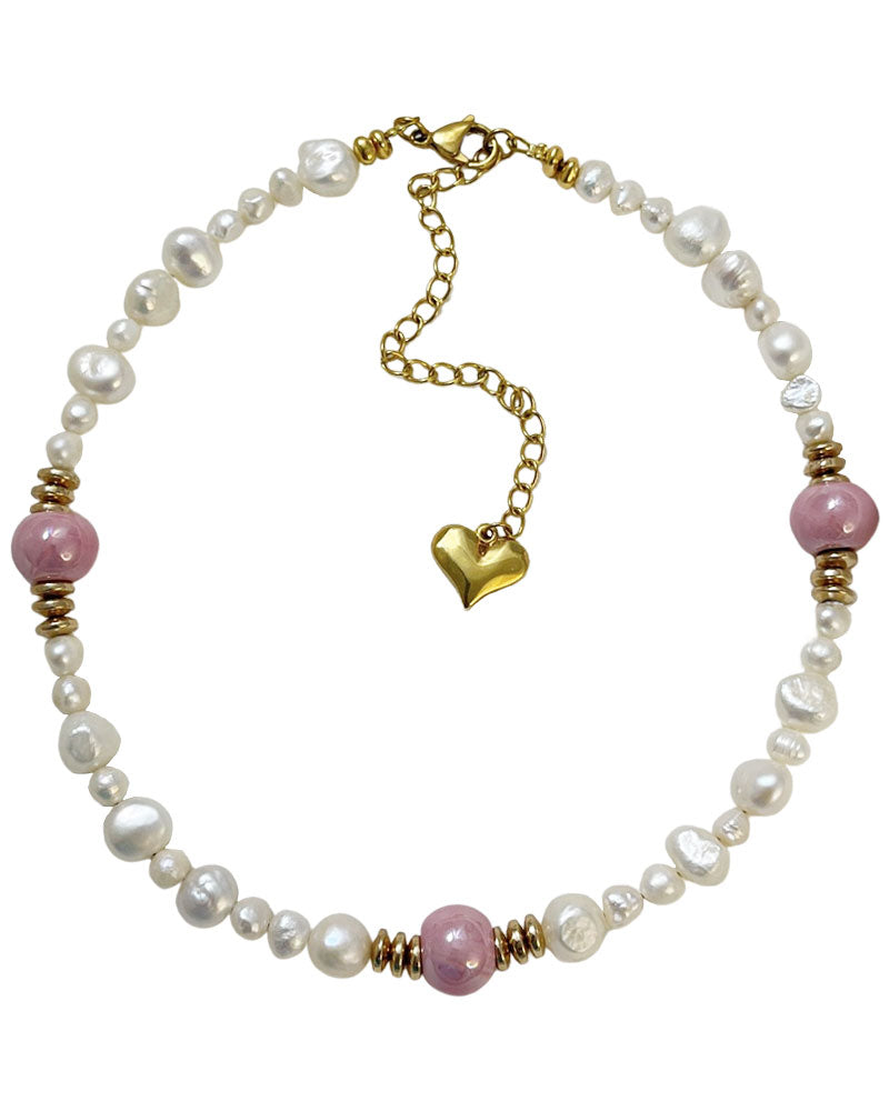 A handmade necklace with freshwater pearls adorned with gold hematite and pink ceramic beads