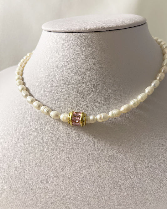 pearl choker necklace with a pink crystal bead in the middle