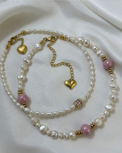 pearl choker necklace with a pink crystal bead in the middle