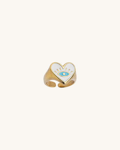 Gold chunky ring with white enamel heart shape and an evil eye